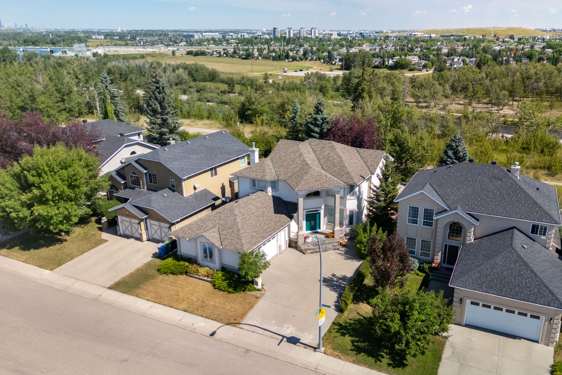 Aerial view of the home backing onto the Bow River valley green space